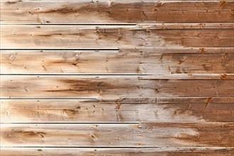 Horizontal weathered wood background with brown colored planks with fading colors