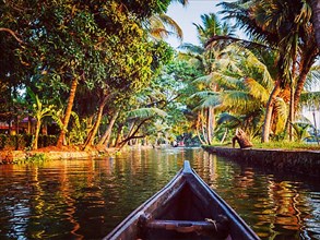 Vintage retro effect hipster style image of Kerala backwaters tourism travel in canoe. Kerala