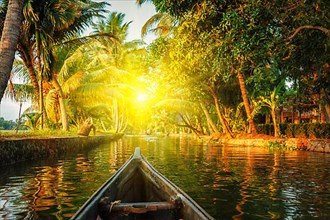 Kerala backwaters tourism travel in canoe on sunset. Kerala