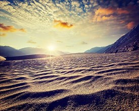 Vintage retro effect filtered hipster style image of sand dunes in Himalayas on sunrise. Hunder
