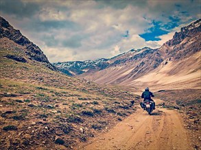Vintage retro effect filtered hipster style image of motorcycle bike on mountain road in Himalayas. Spiti Valley
