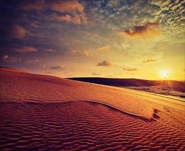 Vintage retro effect filtered hipster style image of white sand dunes on sunset