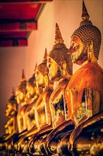Vintage retro effect filtered hipster style image of sitting Buddha statues in Buddhist temple Wat Pho