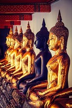 Vintage retro effect filtered hipster style image of sitting Buddha statues in Buddhist temple Wat Pho