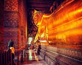 Vintage retro effect filtered hipster style image of reclining Buddha gold statue. Wat Pho