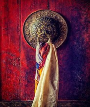 Vintage retro effect filtered hipster style image of door handle of gates of Thiksey gompa