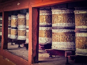 Vintage retro effect filtered hipster style image of Buddhist prayer wheels in Hemis gompa