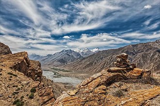 View of Spiti valley in Himalayas with stone cairn on cliff. Spiti valley