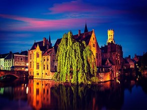 Famous view of Bruges- vintage retro effect filtered hipster style image of Belfry and old houses along canal with tree. Brugge