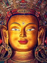 Vintage retro effect filtered hipster style image of Maitreya Buddha statue face close up in Thiksey Gompa. Ladakh