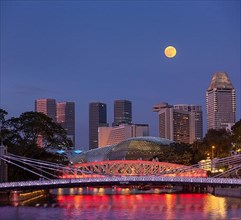 Singapore skyline. Singapore river and Cavenagh Bridge in the evening