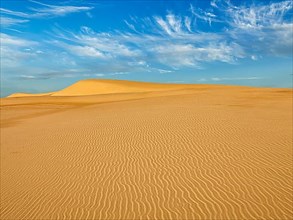 White sand dunes in desert on sunrise