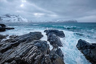 Waves of Norwegian sea crushing at rocky coast in fjord. Vikten