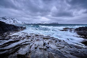 Waves of Norwegian sea crushing at rocky coast in fjord. Vikten