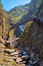 Footbridge on hiking trail with hikers toursits at Biryong Falls Waterfall in Seoraksan National Park