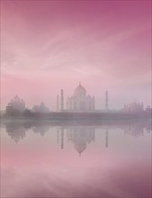 Taj Mahal on sunrise sunset reflection in Yamuna river panorama in fog