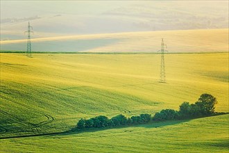Vintage retro effect filtered hipster style image of Moravian summer rolling landcsape with two power line tower. Moravia