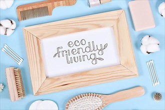 Eco friendly living concept with wooden beauty and hygiene products like comb and soap on blue background