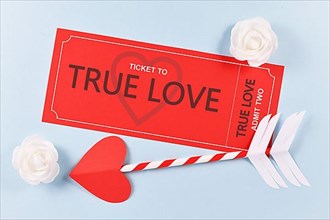 Red True Love ticket and cupid arrow on blue background for Valentines day