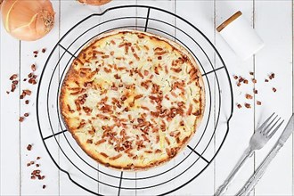 Top view of pizza-like food called 'Tarte Flambee' or 'Flammkuchen' from German-French Alsace border region