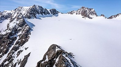 Aerial view of a group of alpinists in the high mountains with the glacier Lisener Ferner