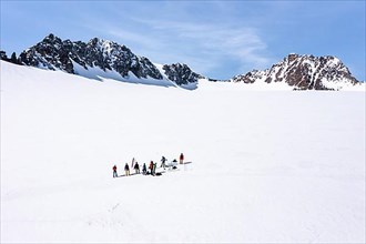 Aerial view of a group of alpinists in the high mountains with the glacier Lisener Ferner