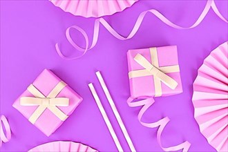 Violet party flat lay with pink gift boxes