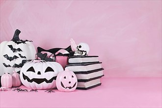 Pink Halloween decor with black and white pumpkins
