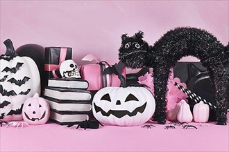 Pink Halloween decor with black and white pumpkins