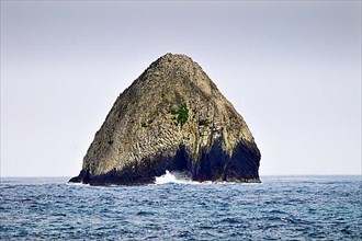 Lonely rock with surf at Cocos Island