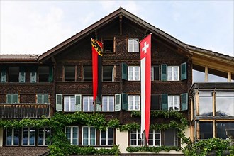 House flagging Swiss and Bernese flag