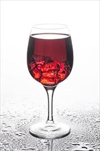 Glass of wine with ice crystals on a glass background