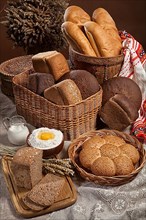 Still life with different kinds of bread on a tablecloth