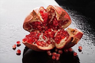 Pomegranate on a glass background with drops of water