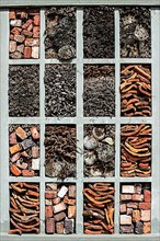 Insect hotel with artificial nesting facilities for solitary bees and cavities for hibernating ladybirds and other insects