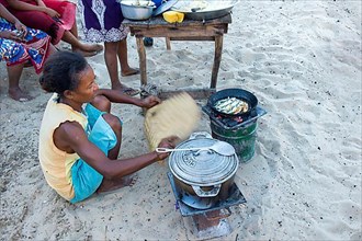 Malagasy woman cooking outdoors