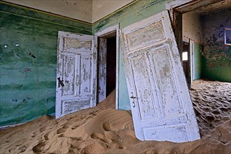 Residential buildings taken over by desert sand