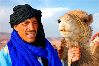 Man with dromedary camel