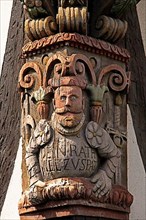Artful carvings on corner beams of half-timbered house
