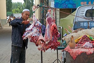 Mobile butcher cutting meat from his pickup truck in Waxxari village