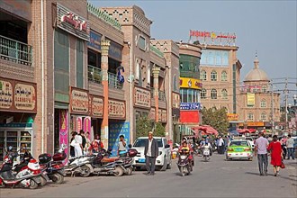 Scooter in busy shopping street in Kashgar city
