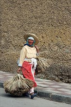 Old Berber woman carrying goods to market in Tetouan