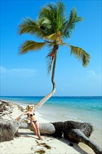 Woman on the beach with palm trees