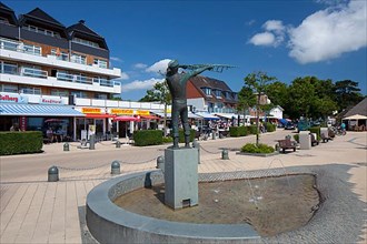 Statue and snack bars on the beach promenade in the seaside resort of Haffkrug