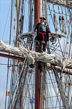 Buccaneer captain overlooking the sea from the mast during the maritime festival Oostende voor Anker