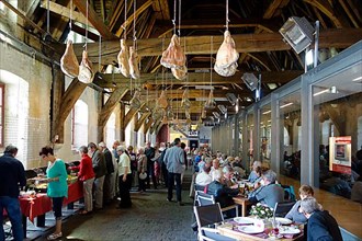 Hams hanging from the ceiling inside the Groot Vleeshuis