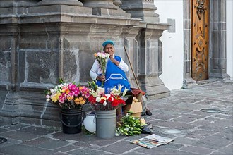 Woman selling flowers in front of Sagrario Church