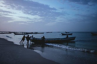 Fishing boats set sail at dawn