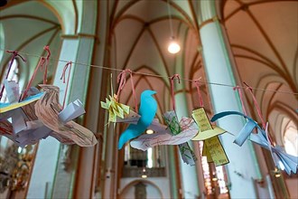 Peace doves made of paper hang in the main Protestant church St. Johannis