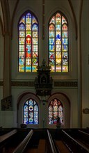 Side aisle with stained glass windows in the main Protestant church of St. Johannis